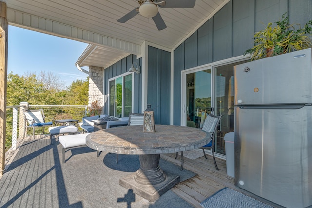 view of patio featuring ceiling fan and a deck