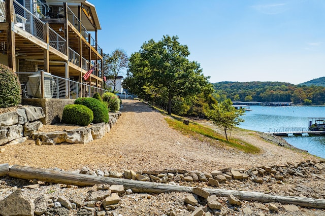 view of yard featuring a water view and a boat dock