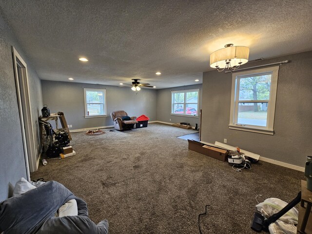 1101 E 18th St, Lamar, MO 64759 - interior space with ceiling fan, carpet, plenty of natural light, and a textured ceiling