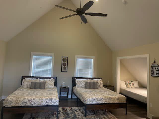 bedroom featuring ceiling fan, high vaulted ceiling, and wood finished floors