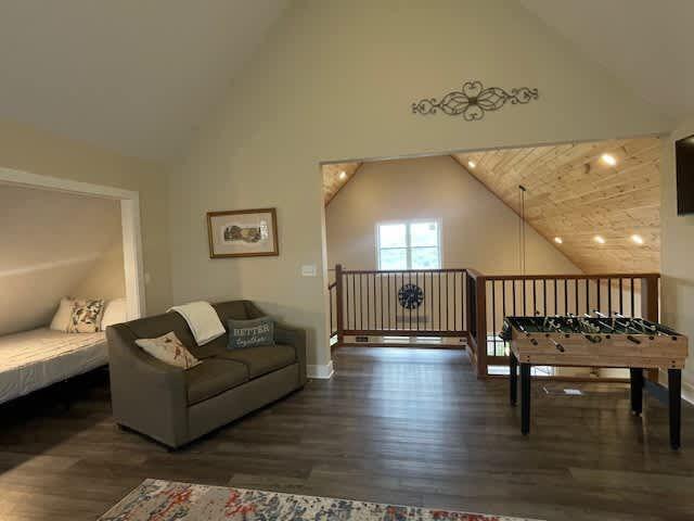 interior space featuring high vaulted ceiling and wood finished floors