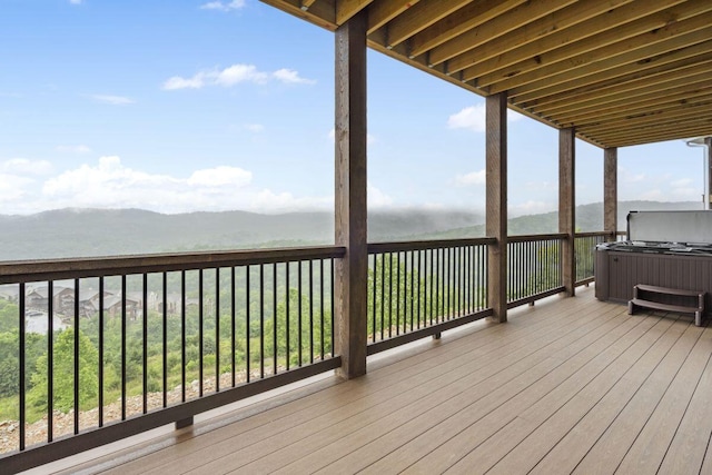 deck featuring a mountain view and a hot tub