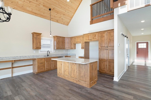 kitchen featuring a barn door, visible vents, a wealth of natural light, and a sink