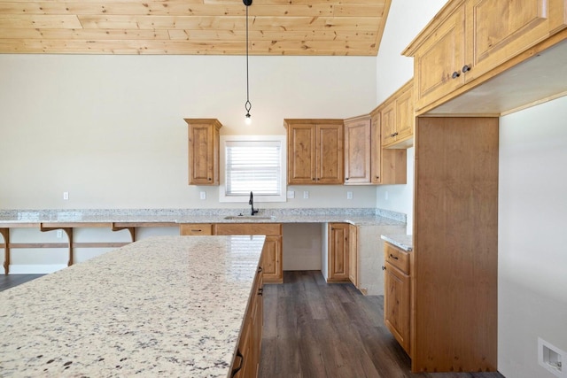 kitchen featuring visible vents, dark wood-type flooring, a sink, light stone countertops, and vaulted ceiling