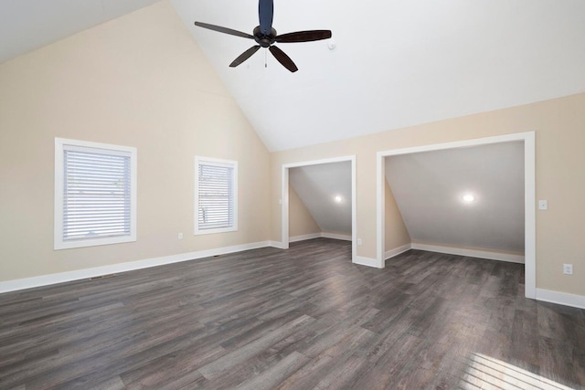 interior space with ceiling fan, baseboards, high vaulted ceiling, and dark wood finished floors