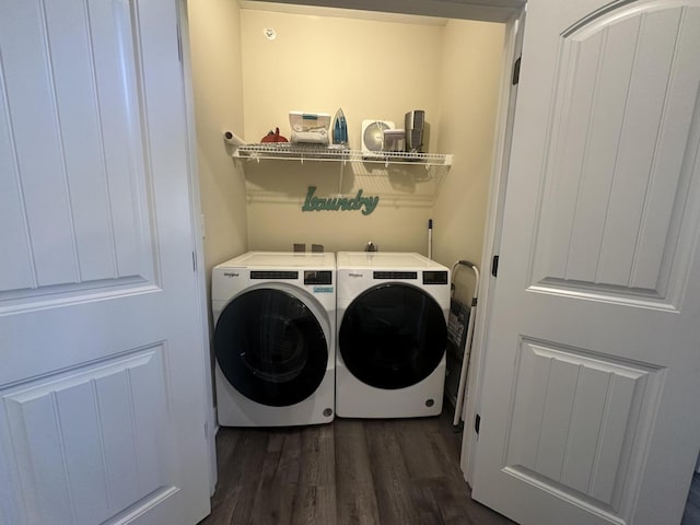 clothes washing area featuring laundry area, dark wood-style floors, and washer and clothes dryer