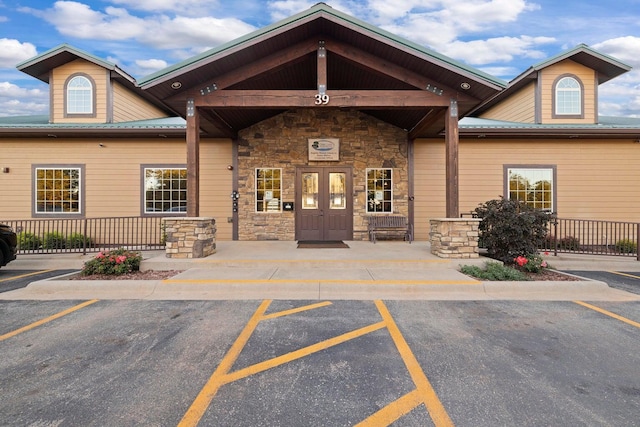 property entrance featuring metal roof and stone siding