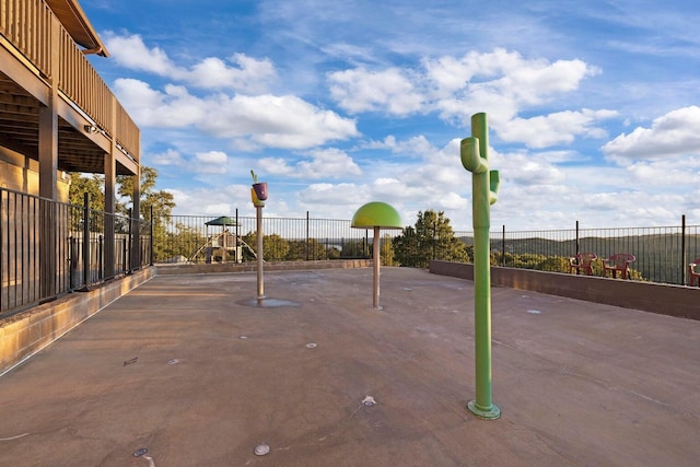 view of patio / terrace with playground community and fence