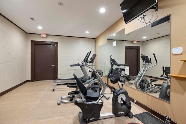 workout area with concrete block wall, recessed lighting, and visible vents