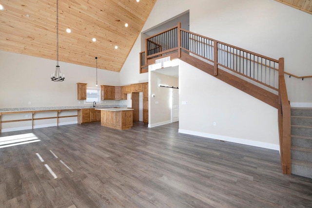 unfurnished living room with dark wood-style floors, recessed lighting, stairway, wooden ceiling, and baseboards