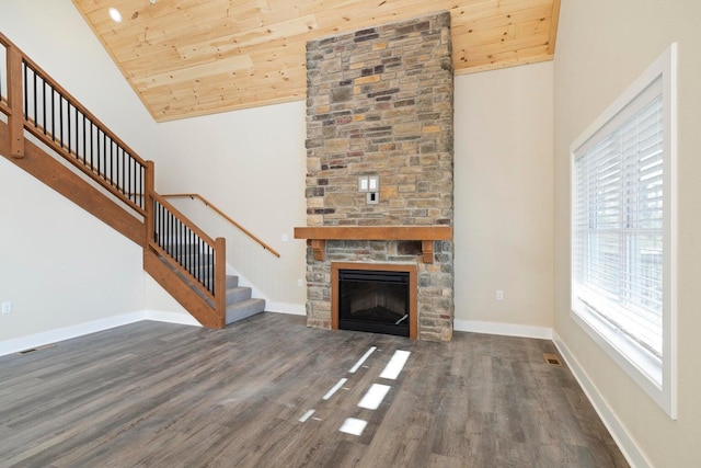 unfurnished living room with high vaulted ceiling, wood finished floors, baseboards, wood ceiling, and stairs