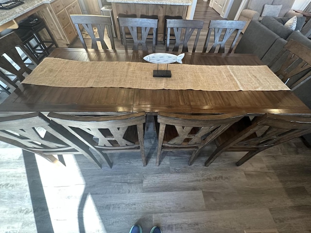 unfurnished dining area with dark wood-style flooring