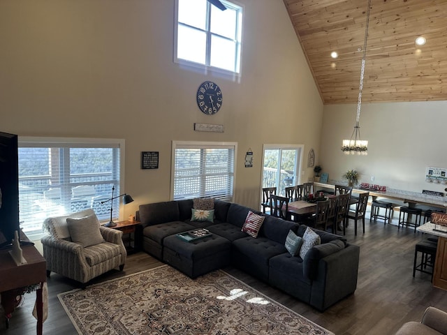 living room featuring wood finished floors, a high ceiling, wood ceiling, and a chandelier