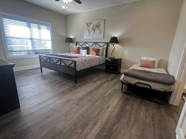 bedroom with ceiling fan, baseboards, and wood finished floors