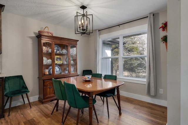 dining area featuring a notable chandelier and hardwood / wood-style flooring