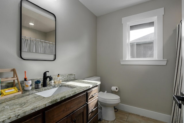 bathroom featuring vanity, toilet, and wood-type flooring