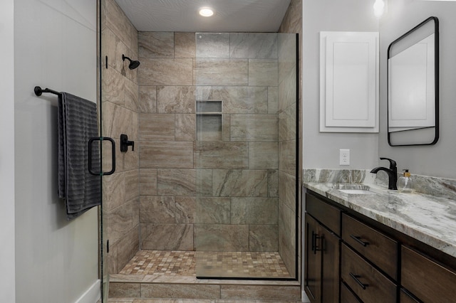 bathroom featuring vanity and a shower with shower door