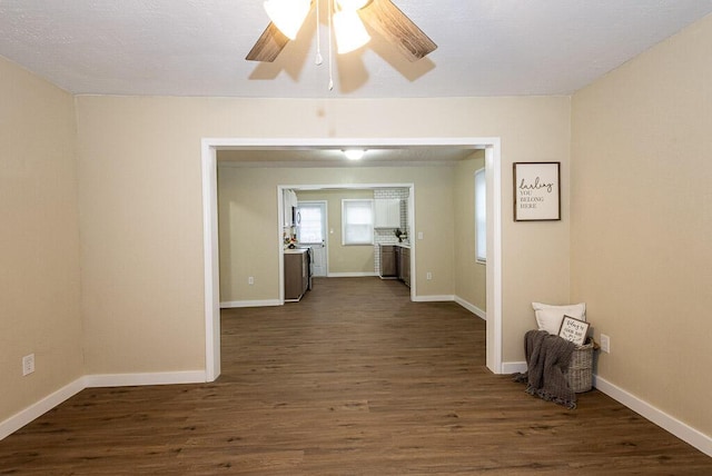 unfurnished room featuring ceiling fan and dark hardwood / wood-style floors