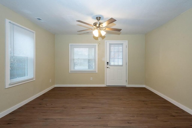 interior space featuring dark wood-type flooring and ceiling fan