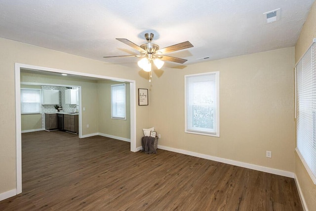 spare room featuring sink, dark hardwood / wood-style floors, and ceiling fan