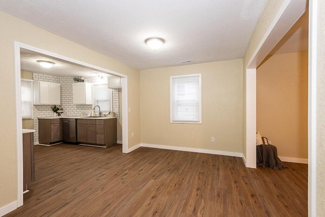 kitchen featuring tasteful backsplash, sink, dark wood-type flooring, and white cabinets