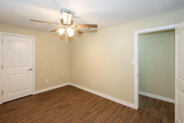 unfurnished bedroom with dark hardwood / wood-style floors and ceiling fan