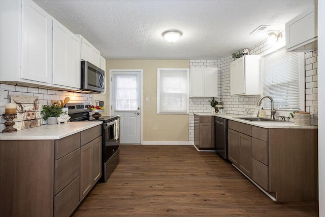 kitchen featuring sink, stainless steel appliances, dark hardwood / wood-style floors, and white cabinets