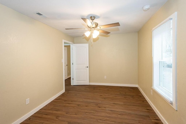 unfurnished room with ceiling fan and dark hardwood / wood-style floors