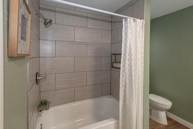 bathroom featuring hardwood / wood-style flooring, shower / bath combo, and toilet