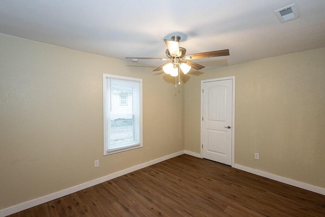 spare room featuring dark hardwood / wood-style floors and ceiling fan