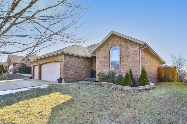 view of front of house featuring a garage and a front lawn