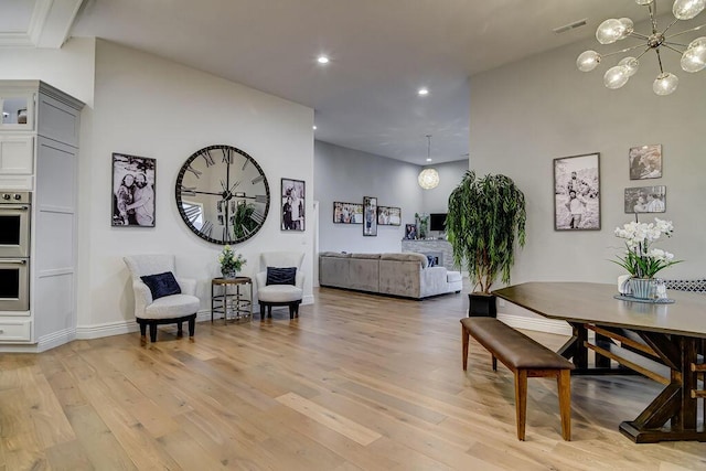 dining room with a notable chandelier and light hardwood / wood-style flooring