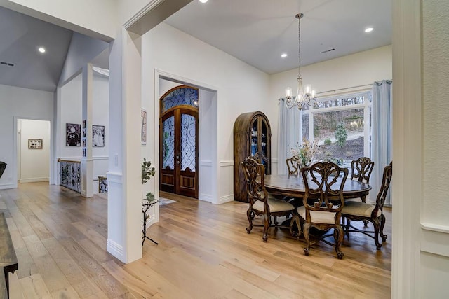 dining room featuring french doors, a chandelier, and light hardwood / wood-style flooring