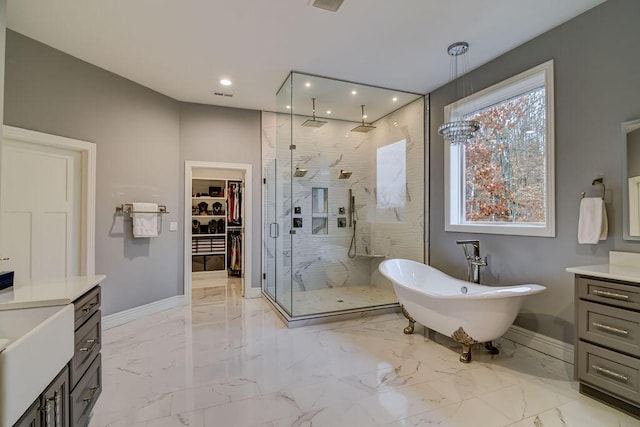 bathroom with vanity and separate shower and tub