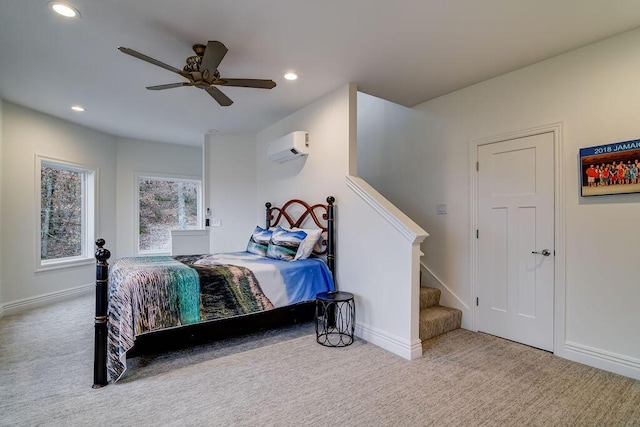 carpeted bedroom featuring ceiling fan and a wall unit AC