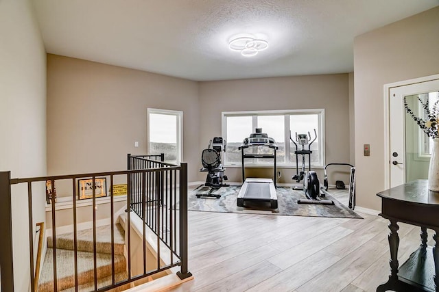 exercise area with plenty of natural light and light wood-type flooring