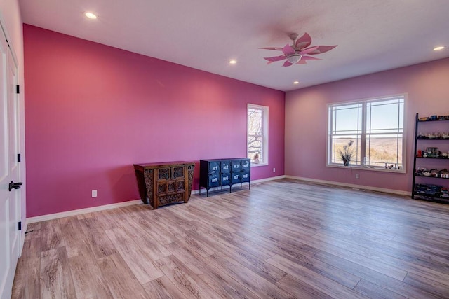 unfurnished living room featuring ceiling fan and light hardwood / wood-style flooring