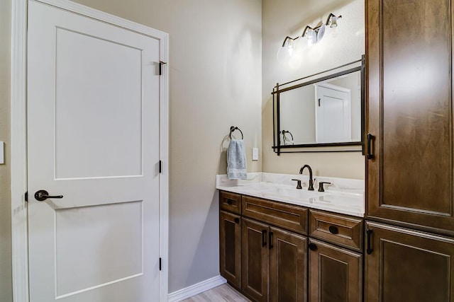 bathroom featuring vanity and hardwood / wood-style floors