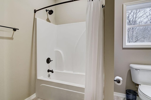 bathroom featuring toilet and shower / bath combo with shower curtain