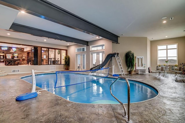 view of swimming pool with french doors