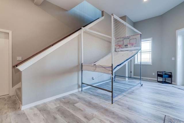 stairway with hardwood / wood-style flooring