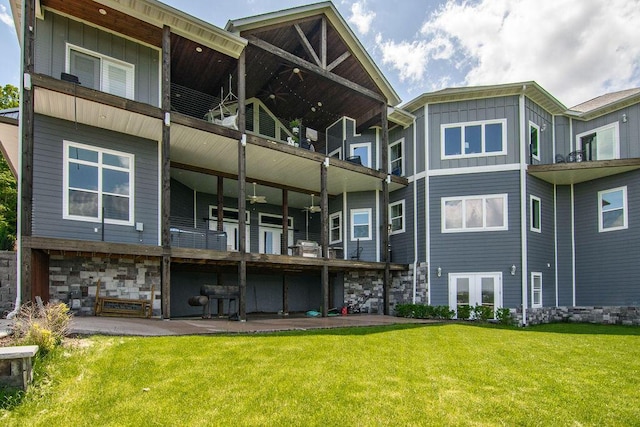 back of property featuring a patio, a yard, and french doors