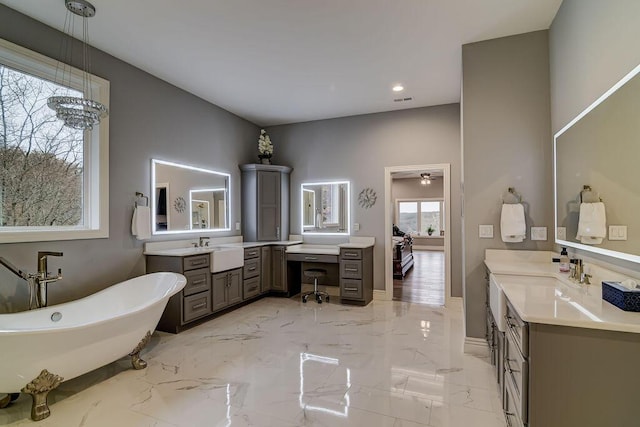 bathroom featuring a tub to relax in and vanity