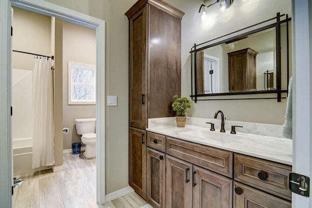 full bathroom featuring vanity, hardwood / wood-style floors, toilet, and shower / bath combo with shower curtain