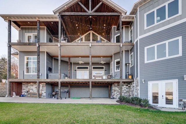 rear view of house featuring french doors, ceiling fan, a balcony, and a patio area