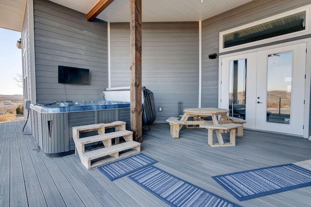 wooden terrace with french doors and a hot tub