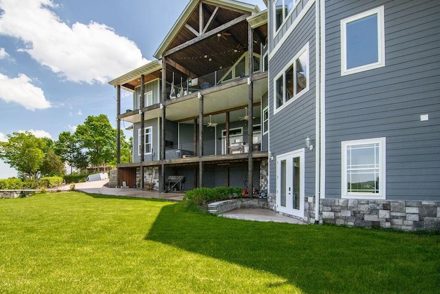 back of house featuring a yard and a patio area