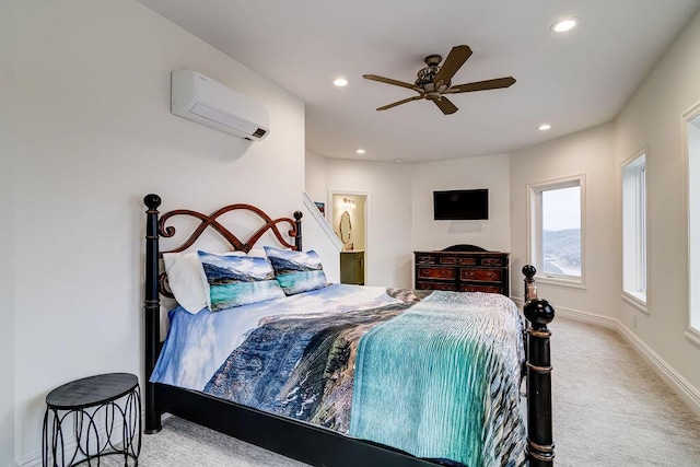 bedroom with ceiling fan, ensuite bathroom, carpet, and a wall unit AC