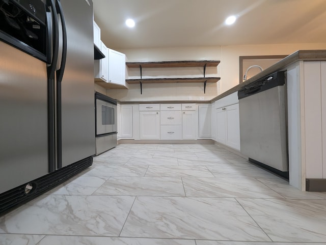 kitchen featuring white cabinetry and appliances with stainless steel finishes