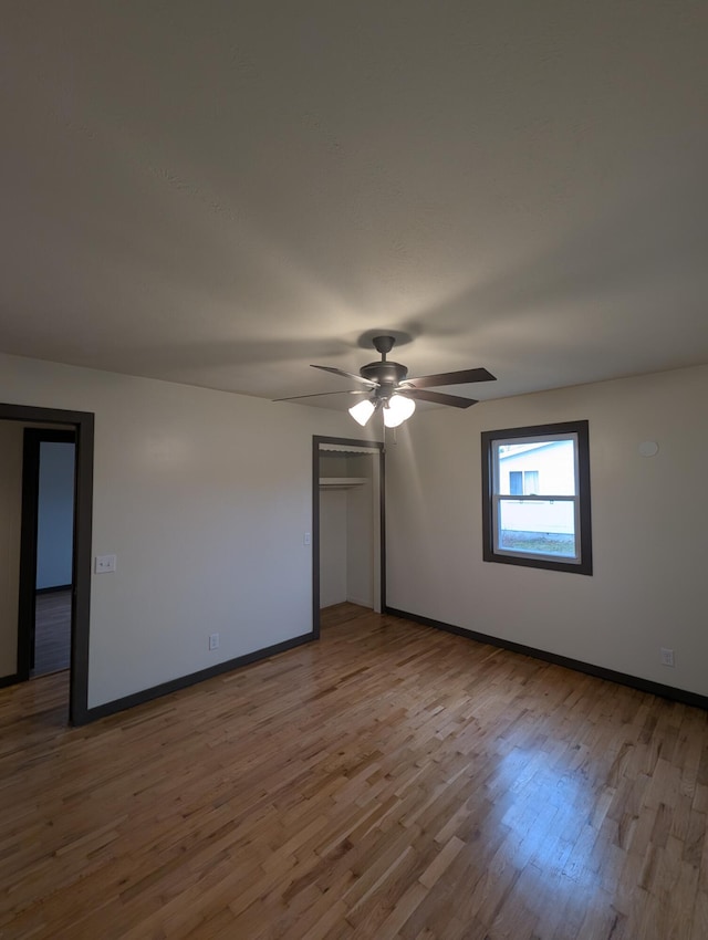 spare room featuring hardwood / wood-style floors and ceiling fan